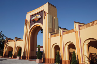 A regal, old Hollywood style arch that serves as the entrance to Universal Studios Florida, a theme park located in Orlando.